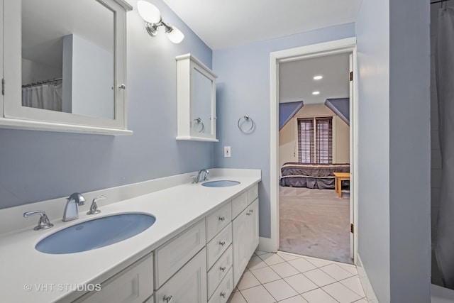 full bath featuring tile patterned floors, a sink, and double vanity