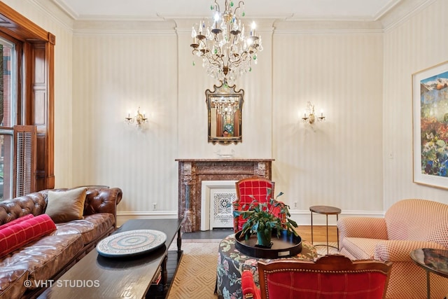 living room featuring baseboards, crown molding, wood finished floors, and an inviting chandelier