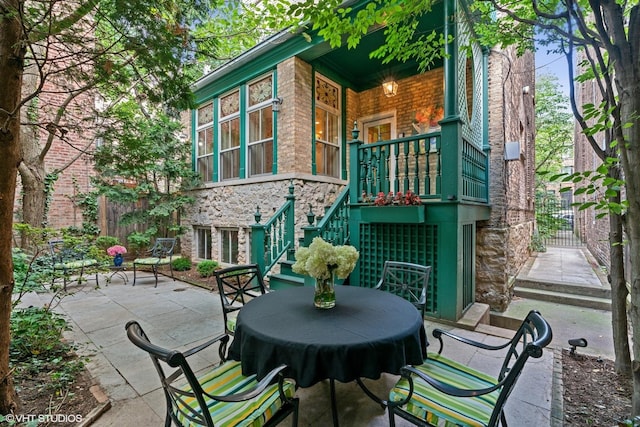 view of patio featuring fence and stairway