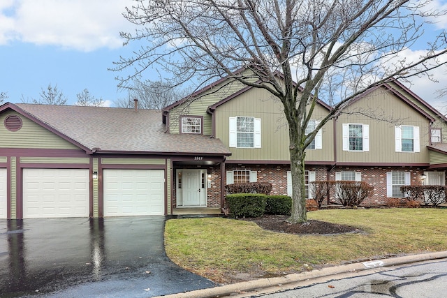 view of front of house featuring a garage and a front lawn