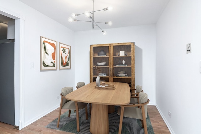 dining area featuring a chandelier and hardwood / wood-style flooring