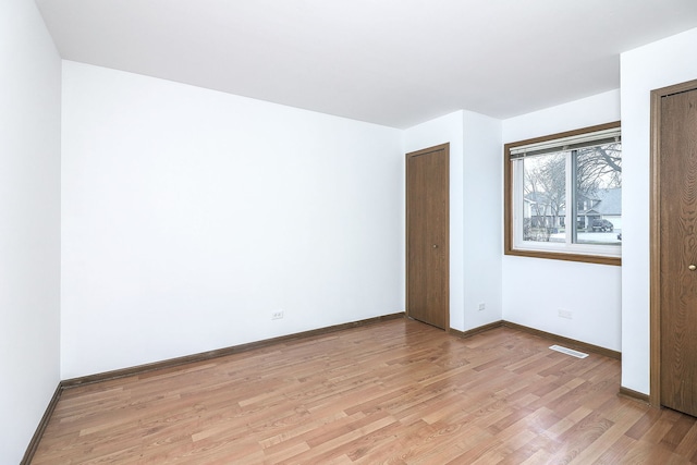 unfurnished bedroom featuring light wood-type flooring