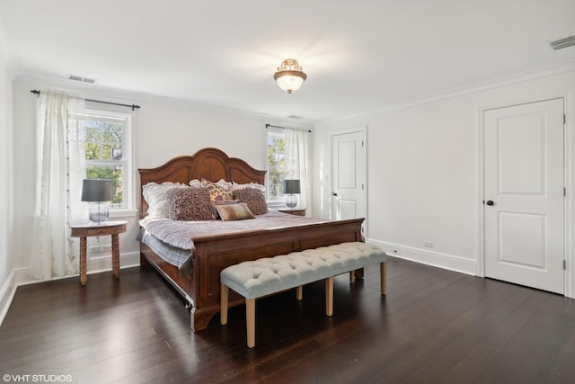 bedroom featuring multiple windows, dark hardwood / wood-style floors, and ornamental molding