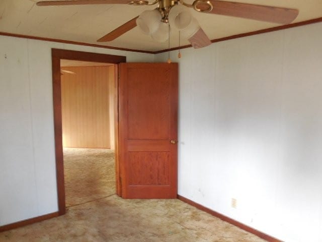 unfurnished room featuring ceiling fan, ornamental molding, and light carpet