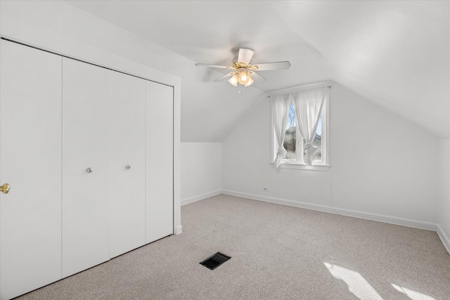 bonus room featuring ceiling fan, light colored carpet, and lofted ceiling