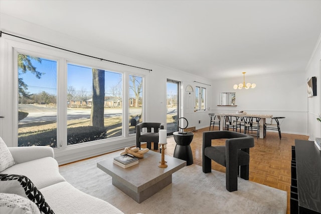 living room with an inviting chandelier and light parquet floors