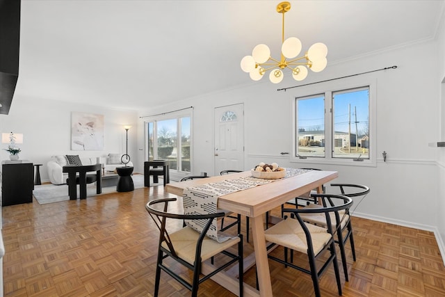 dining room featuring parquet floors, ornamental molding, and a chandelier