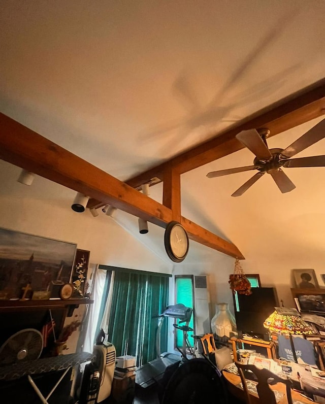 interior space featuring vaulted ceiling with beams and ceiling fan