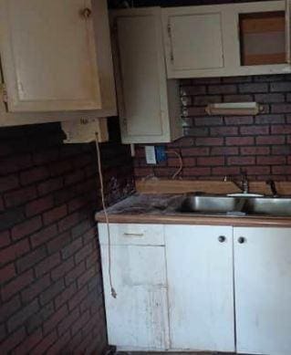 kitchen featuring white cabinets and sink