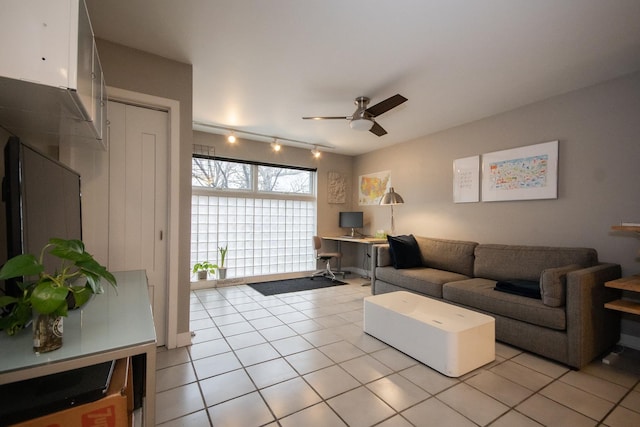 living room featuring light tile patterned floors, rail lighting, and ceiling fan