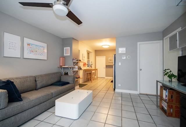 living room with ceiling fan and light tile patterned flooring