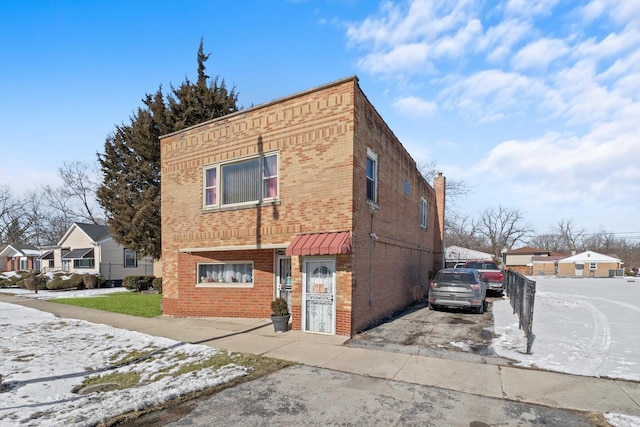 view of front of home with brick siding and a residential view