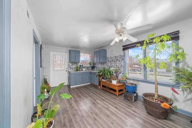 sunroom with plenty of natural light and ceiling fan