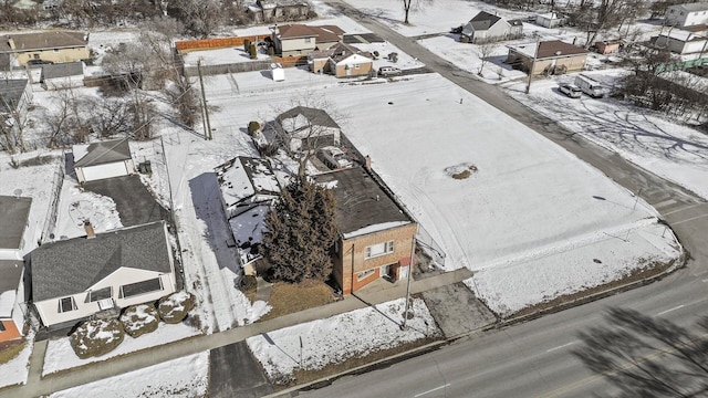 snowy aerial view with a residential view