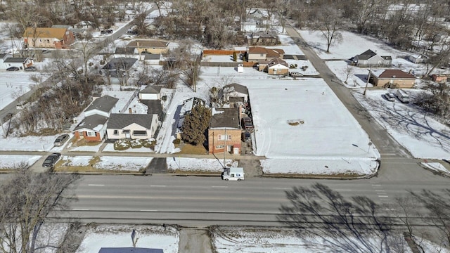 snowy aerial view with a residential view