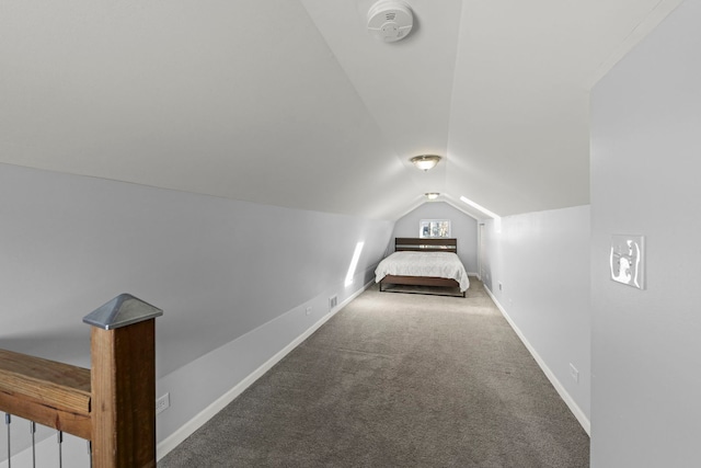 unfurnished bedroom with carpet and vaulted ceiling