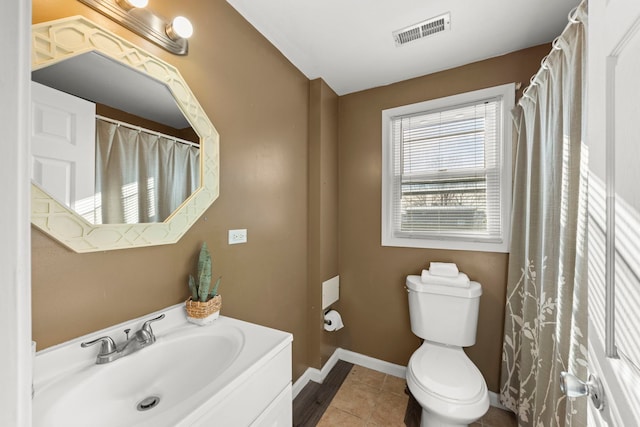 bathroom featuring toilet, vanity, and tile patterned floors