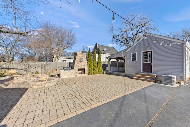 exterior space with an outdoor brick fireplace and cooling unit