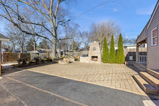 view of patio with an outdoor brick fireplace