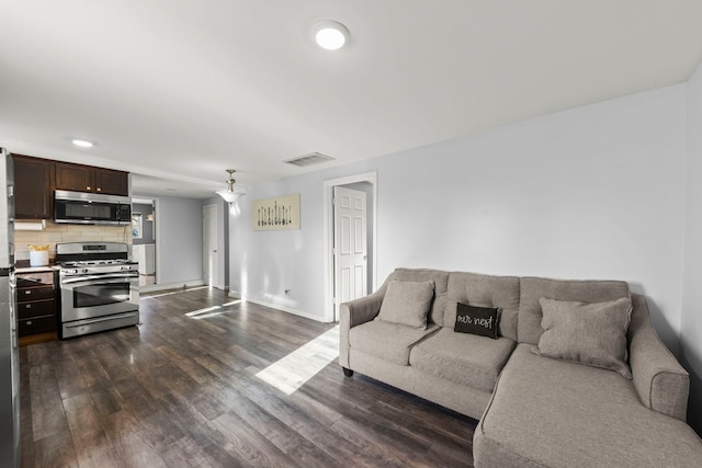 living room with dark hardwood / wood-style flooring