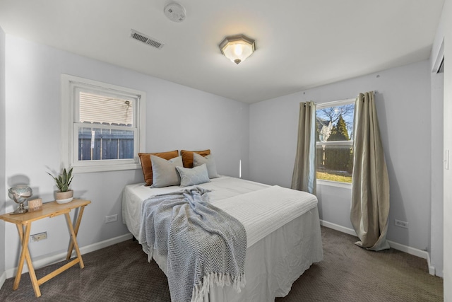 bedroom featuring dark carpet