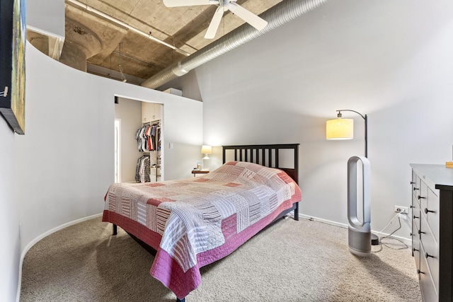 bedroom with ceiling fan, a walk in closet, carpet floors, and a closet