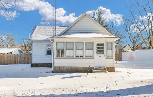 view of snow covered back of property