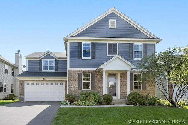 view of front of house with a garage and a front yard