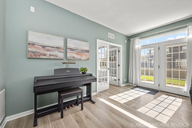 entryway featuring light hardwood / wood-style floors and french doors