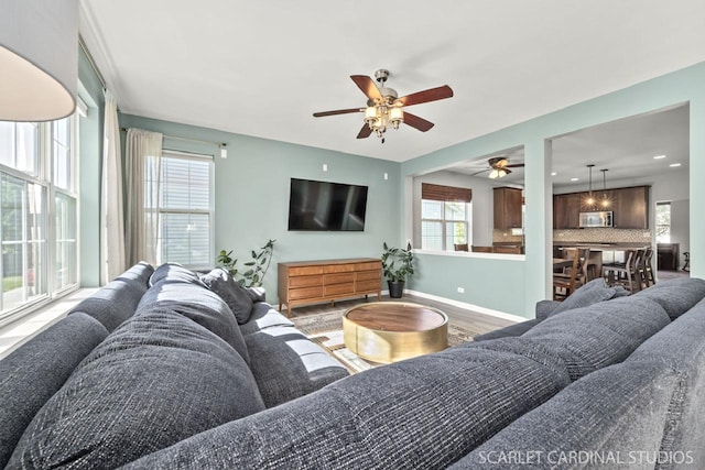 living room with hardwood / wood-style flooring and ceiling fan