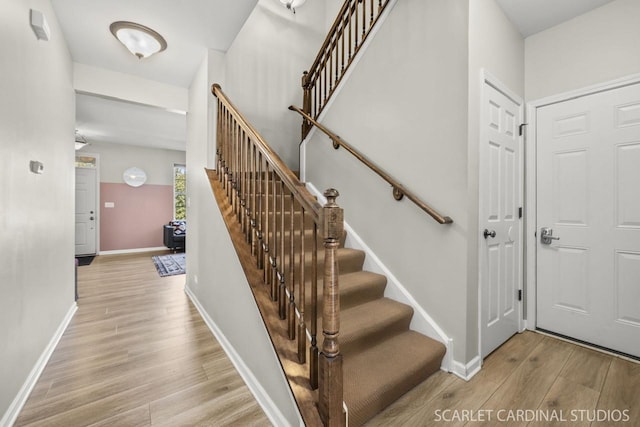 stairway with hardwood / wood-style floors