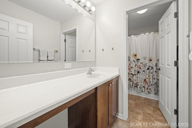 bathroom featuring vanity and a shower with shower curtain