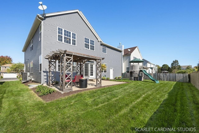 rear view of house featuring a yard, a playground, and a patio