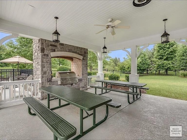 view of patio / terrace featuring area for grilling, a grill, ceiling fan, and a fireplace