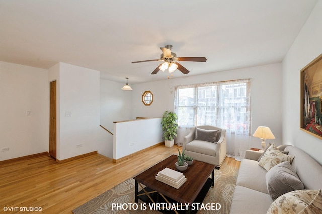 living room featuring light hardwood / wood-style floors and ceiling fan