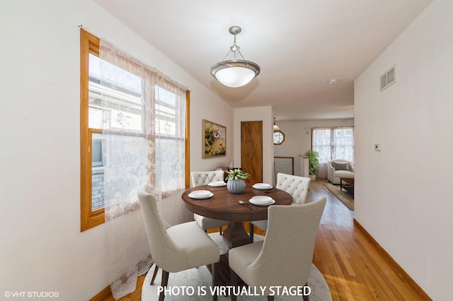 dining space with light hardwood / wood-style flooring