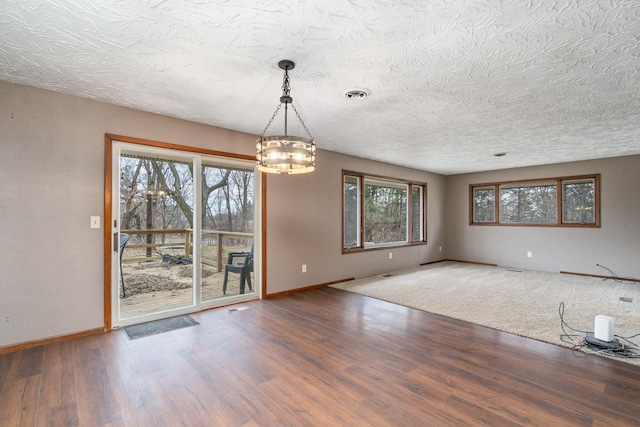 spare room with hardwood / wood-style floors and a textured ceiling