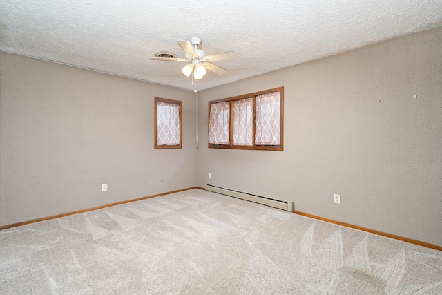 unfurnished room with ceiling fan, carpet flooring, a textured ceiling, and baseboard heating