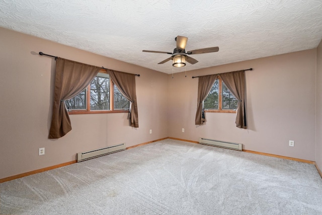 carpeted empty room with ceiling fan, a baseboard radiator, and a textured ceiling