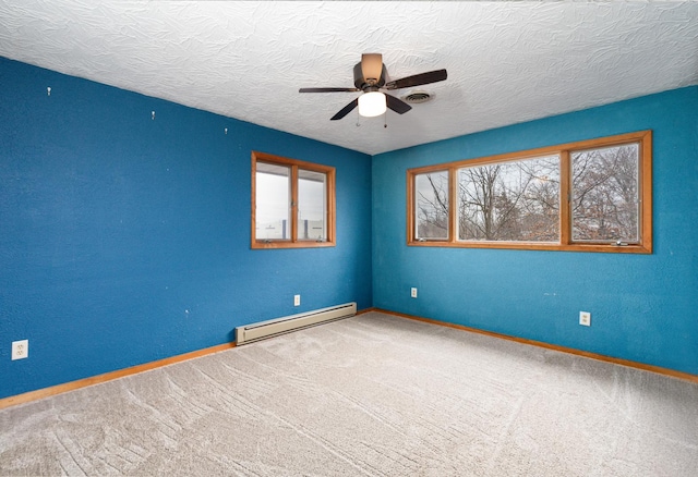 carpeted spare room with a baseboard radiator, a textured ceiling, and ceiling fan