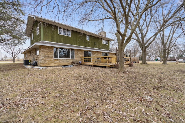 rear view of property with cooling unit and a deck