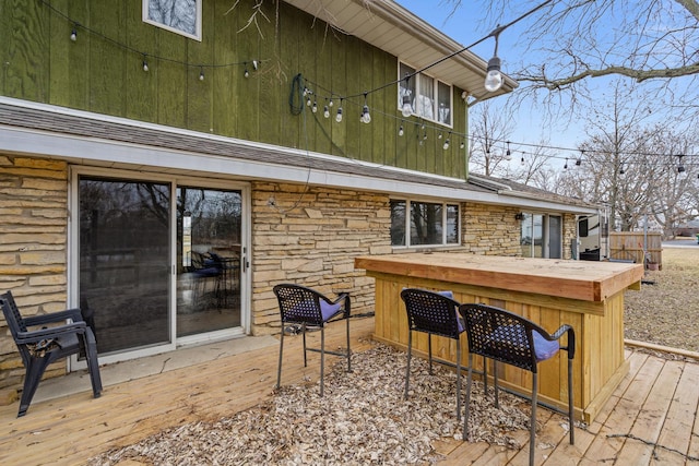 wooden deck featuring exterior bar