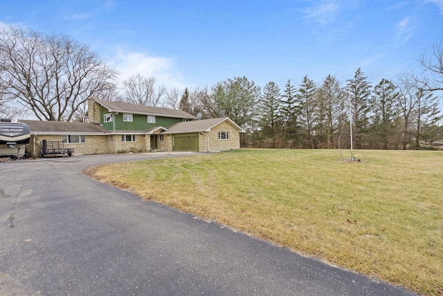 view of front facade with a garage and a front lawn