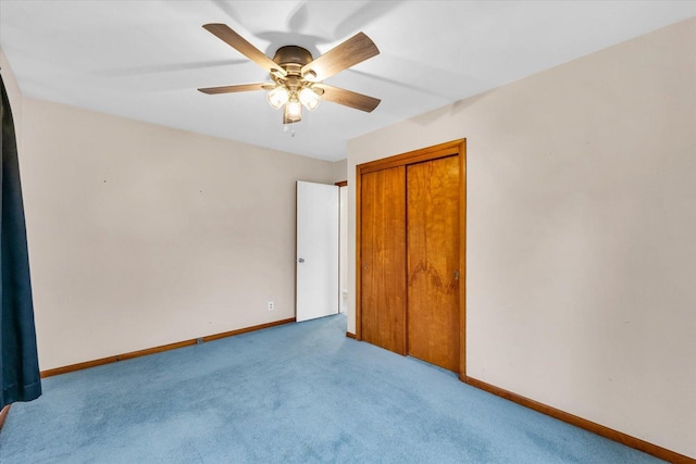 unfurnished bedroom with ceiling fan, a closet, and light carpet