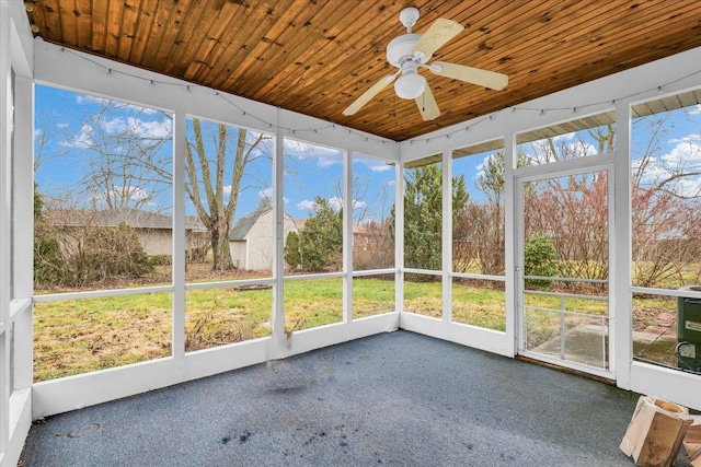 unfurnished sunroom featuring ceiling fan and wooden ceiling