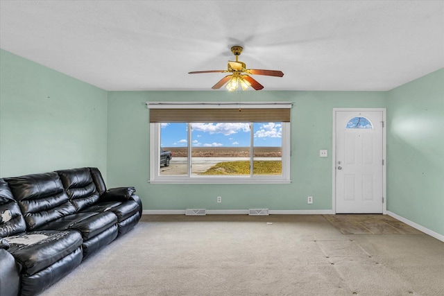 carpeted living room with ceiling fan