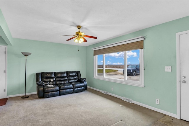 living room with ceiling fan and light carpet