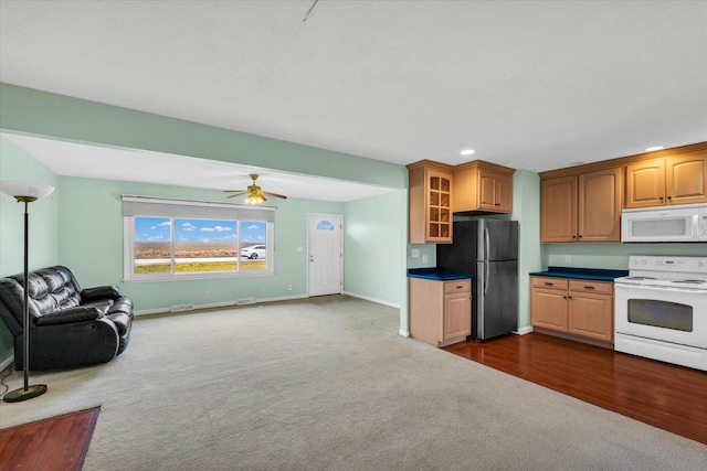 kitchen with ceiling fan, dark carpet, and white appliances