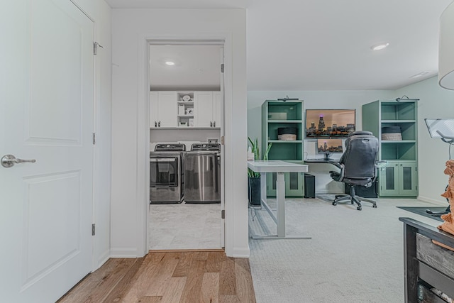 office with hardwood / wood-style flooring and washing machine and dryer