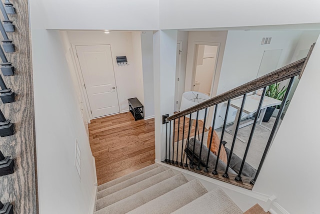 stairway with wood-type flooring